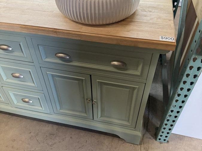 A vanity with a wood top on a showroom floor