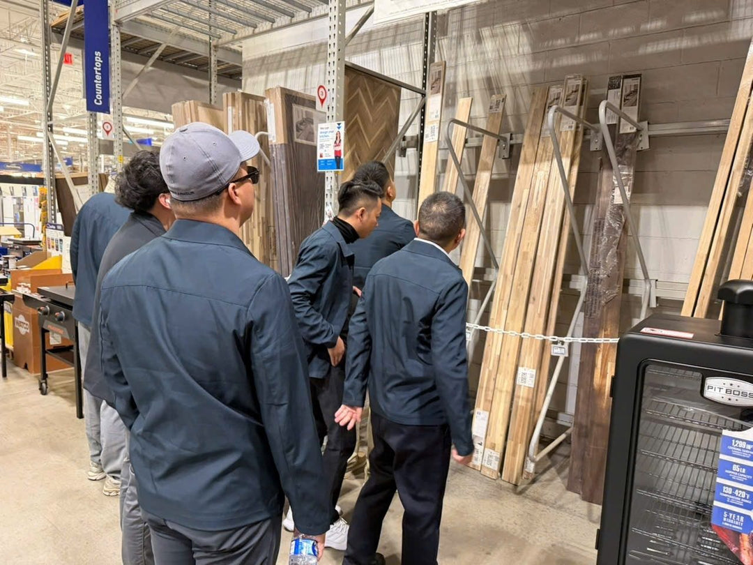 The team doing product research in the countertop aisle of a large retail store