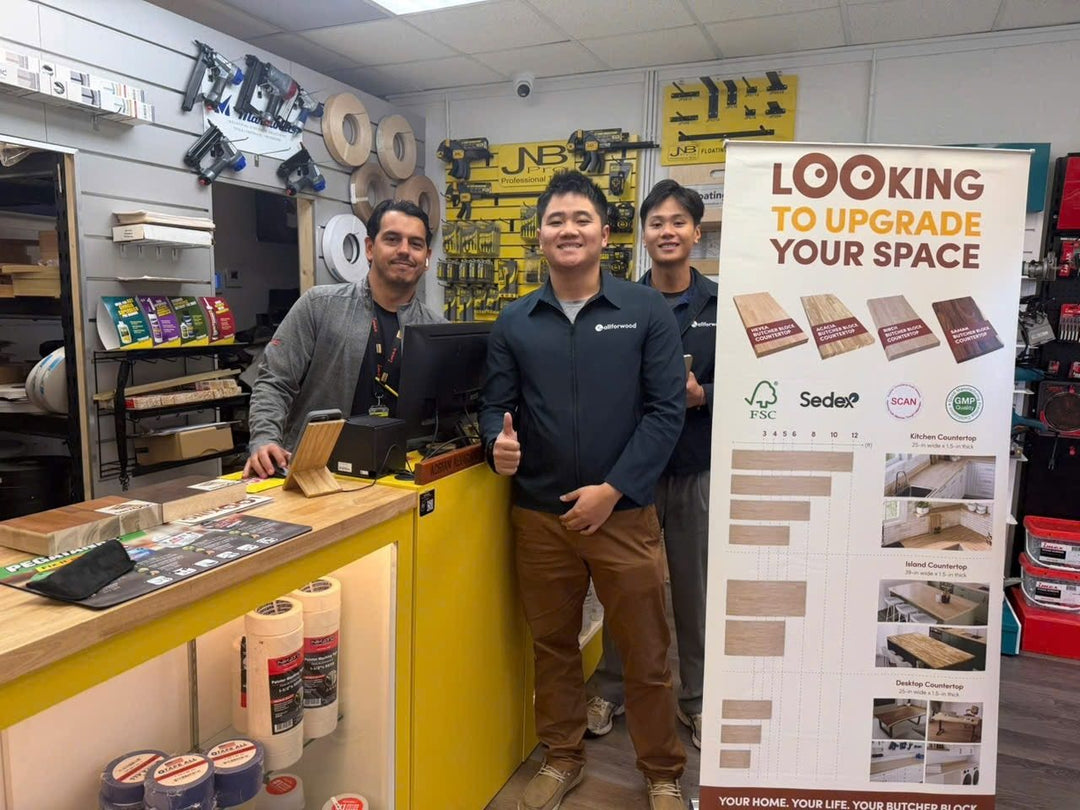 Our team at a hardware store counter with our display stand, on a door-to-door sales visit